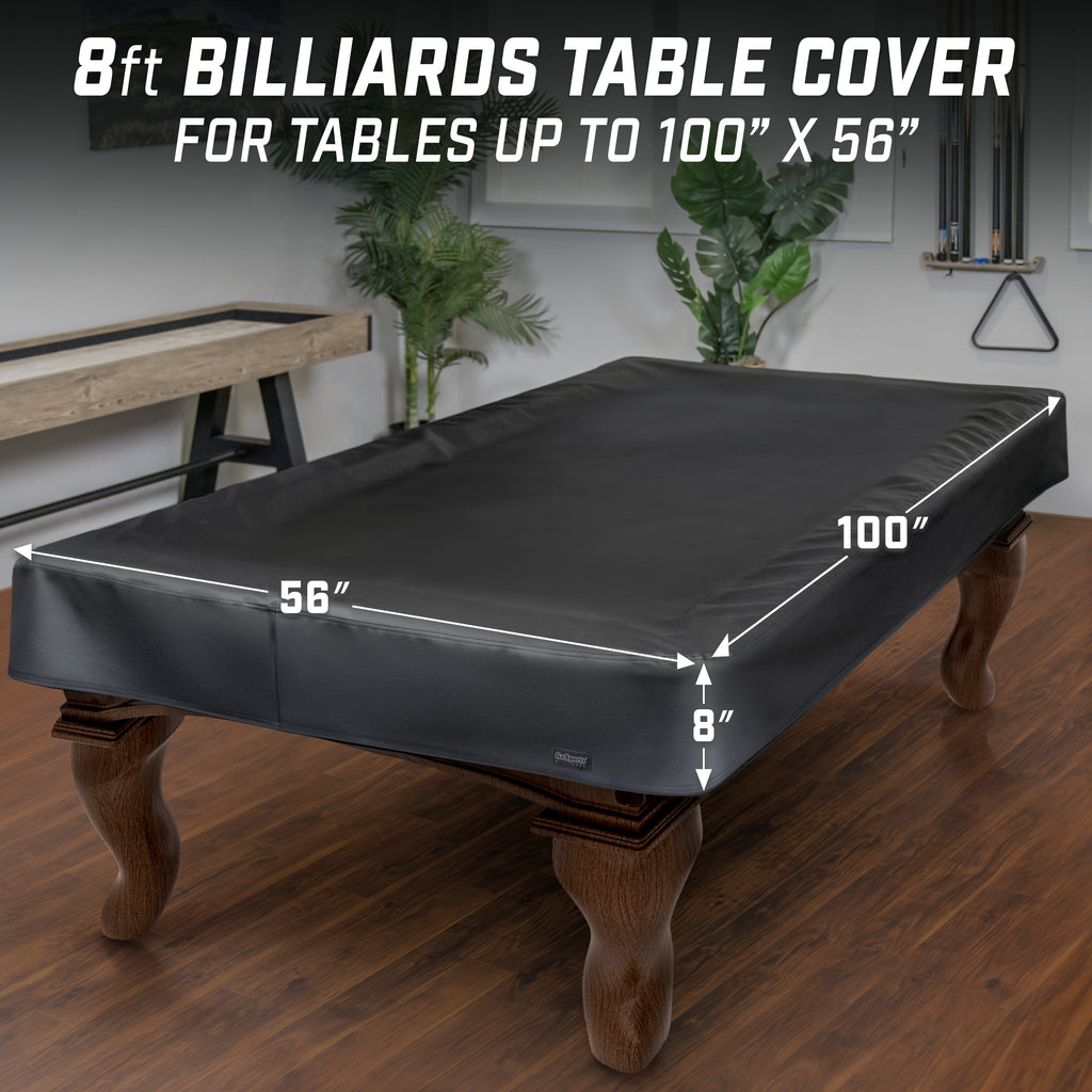 a black pool table cover on a wooden table