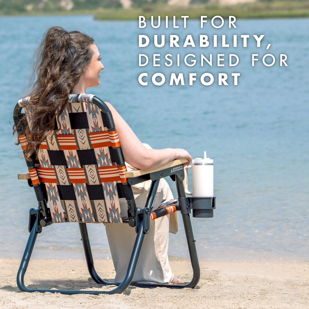 a woman sitting in a chair on the beach