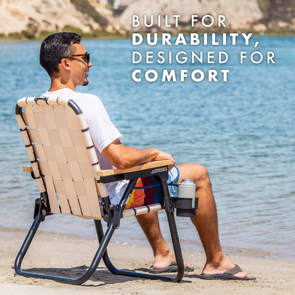 a man sitting in a chair on the beach