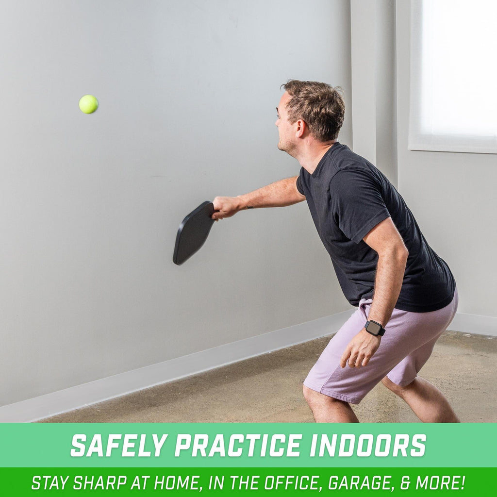 a man is playing with a foam pickleball