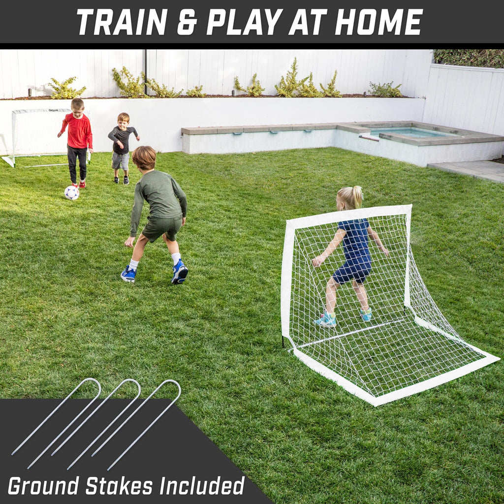 a backyard soccer game with two kids playing in the yard