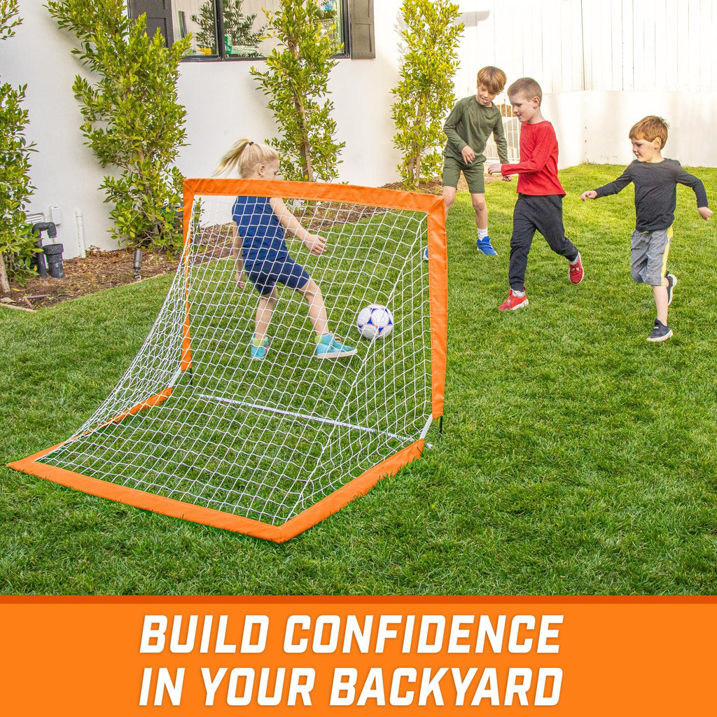 a backyard soccer goal with two kids playing in it