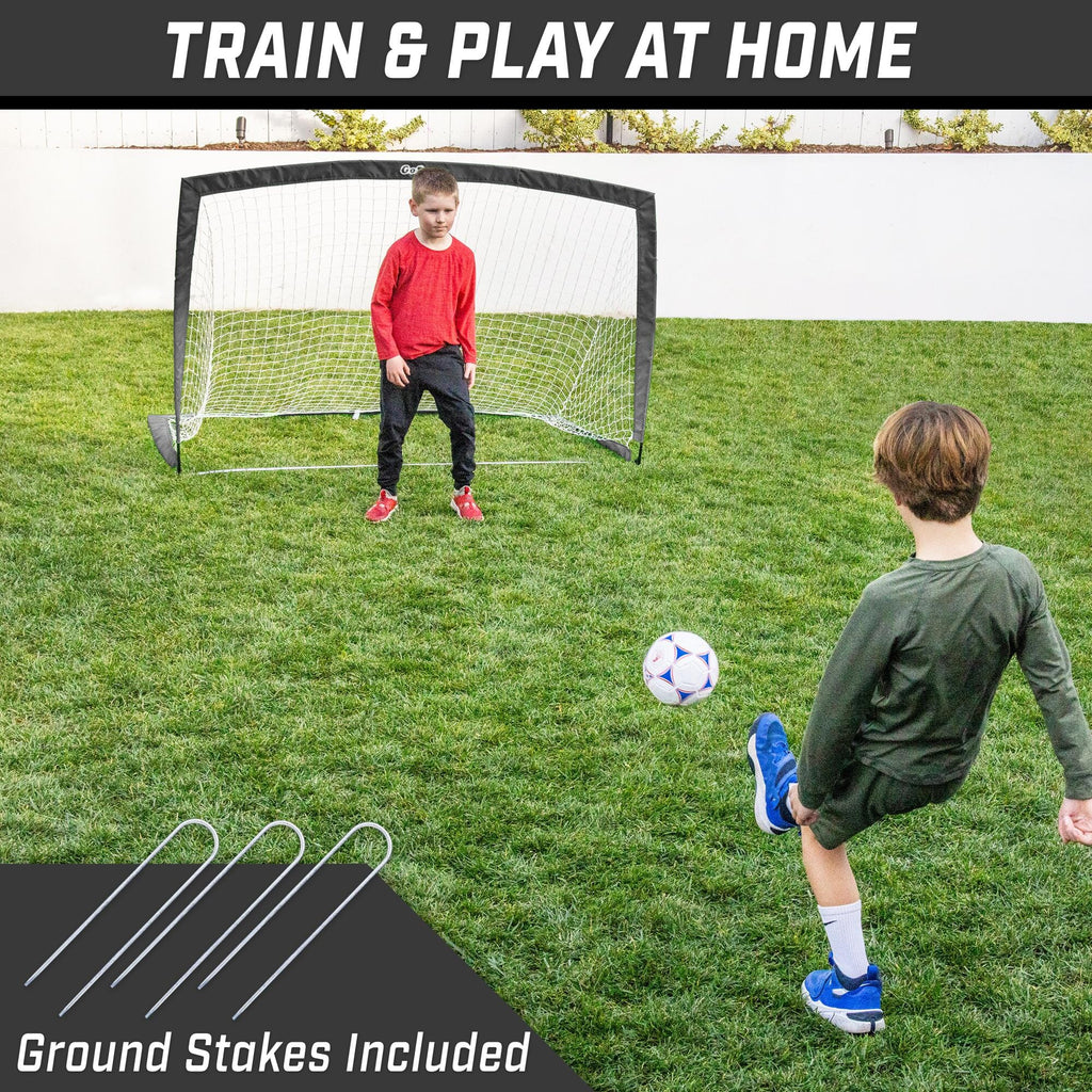 a young boy playing soccer with a soccer ball