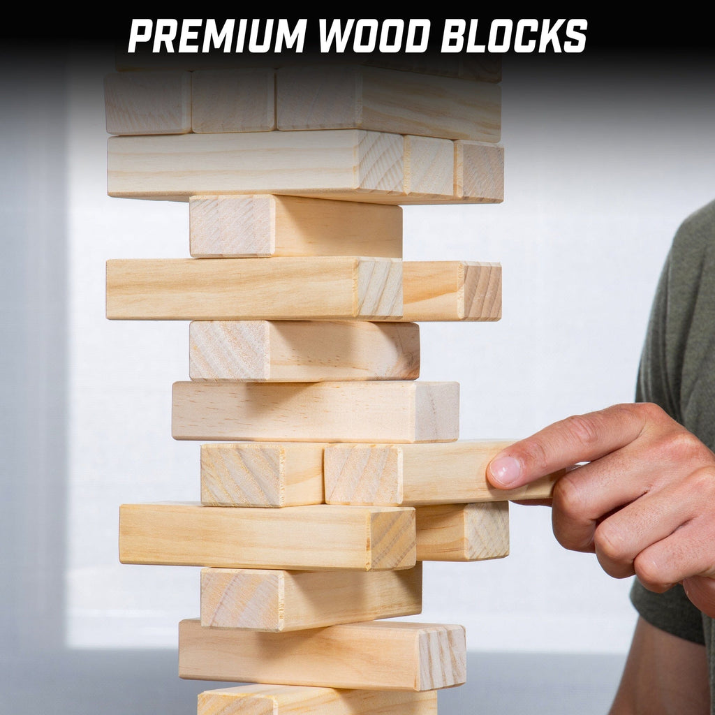 a man is building a tower of wooden blocks