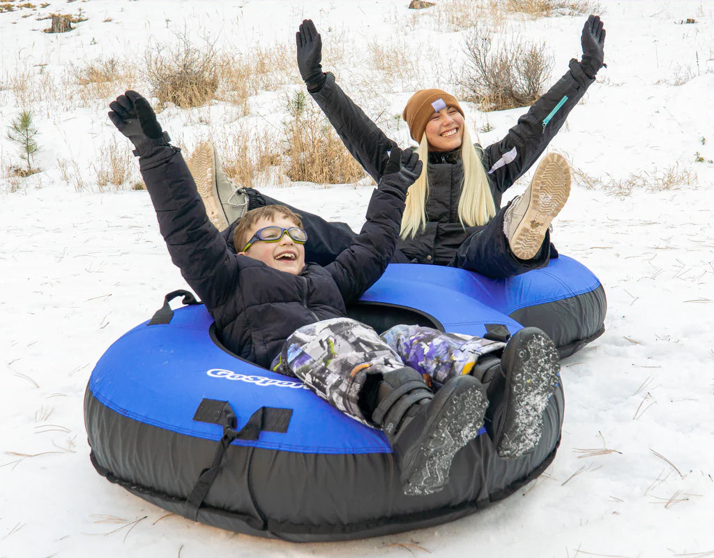 Boy and Female on a blue inflated snow tube text reads "Fun & Functional Commercial Grade Sled"