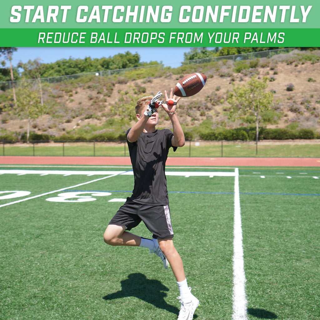 a man in a black shirt and shorts is catching a football